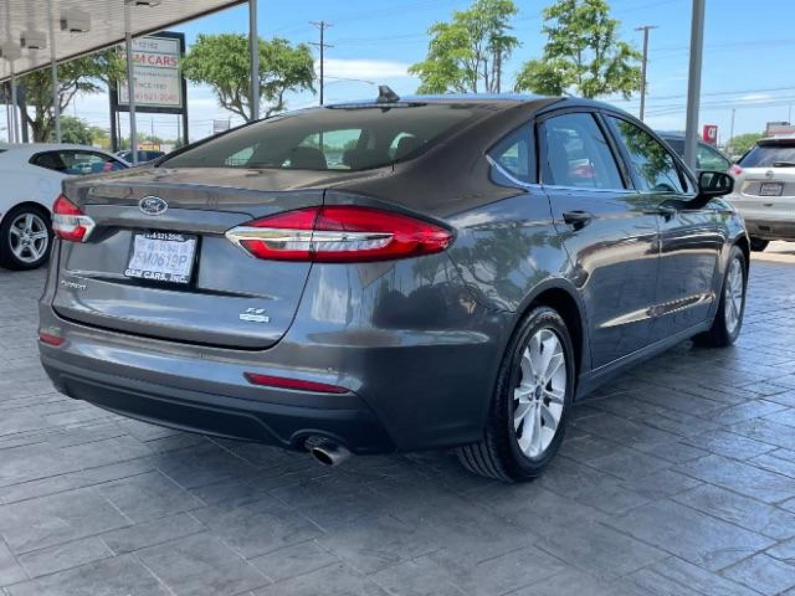 2019 Magnetic Metallic /Ebony, cloth Ford Fusion SE (3FA6P0HD5KR) with an 1.5L L4 DOHC 16V engine, 6-Speed Automatic transmission, located at 12182 Garland Rd, Dallas, TX, 75218, (214) 521-2040, 0.000000, 0.000000 - Photo #2