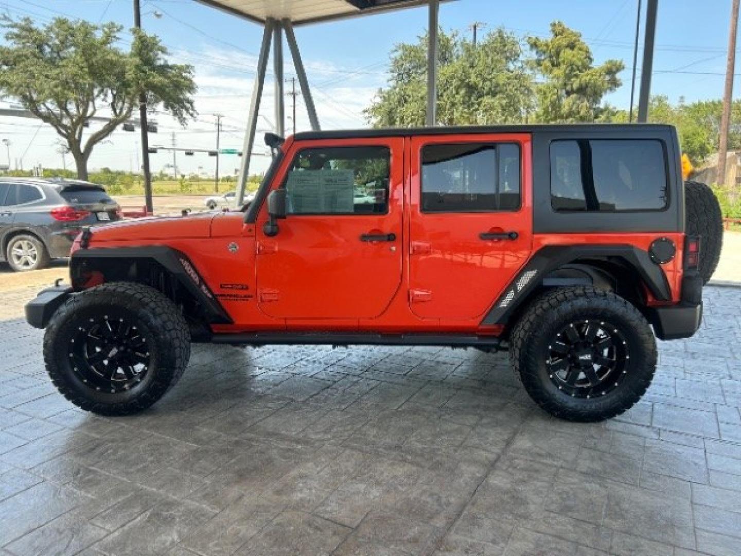 2015 Orange /Black Leather Interior Jeep Wrangler Unlimited Sport 4WD (1C4BJWDG4FL) with an 3.6L V6 DOHC 24V FFV engine, 5-Speed Automatic transmission, located at 12182 Garland Rd, Dallas, TX, 75218, (214) 521-2040, 0.000000, 0.000000- Photo#3